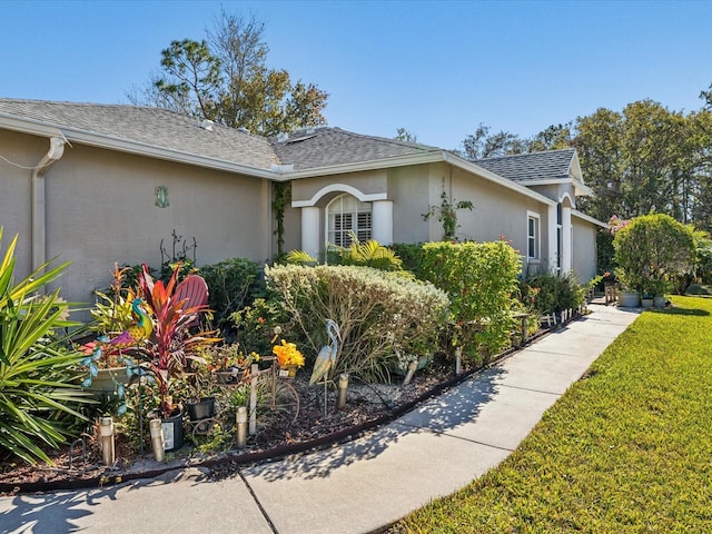 view of property exterior with a lawn