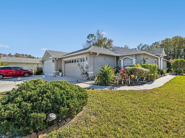 ranch-style home with a garage and a front yard