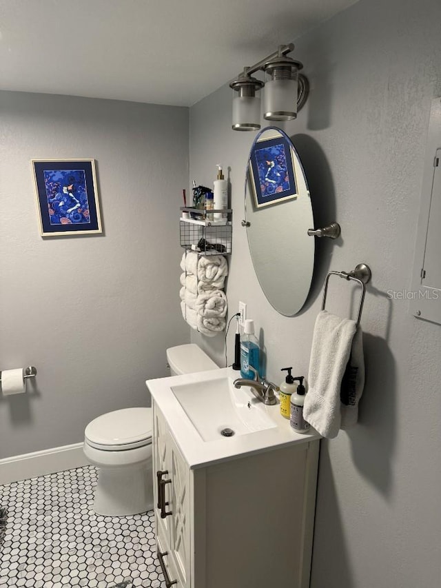 bathroom featuring tile patterned floors, vanity, and toilet