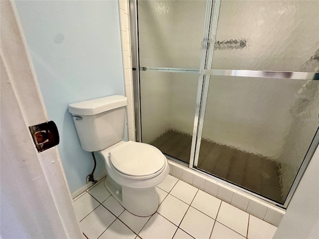 bathroom featuring toilet, tile patterned floors, and walk in shower