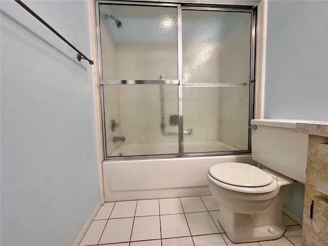 bathroom with tile patterned floors, toilet, and combined bath / shower with glass door