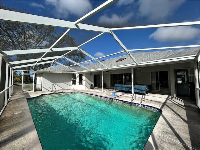 view of swimming pool featuring a lanai and a patio area