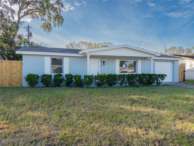 ranch-style home with a garage and a front yard