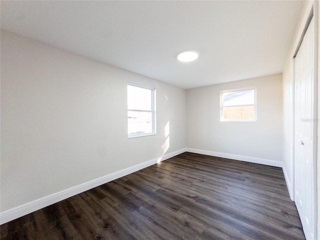 unfurnished bedroom featuring dark hardwood / wood-style flooring