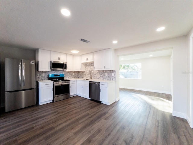 kitchen with white cabinets, stainless steel appliances, dark hardwood / wood-style floors, and sink