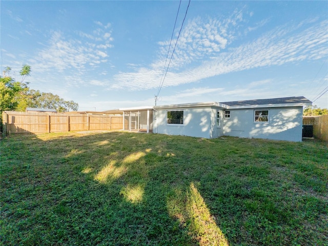 view of yard featuring central AC and a sunroom