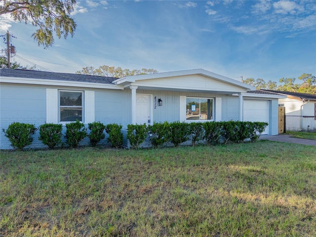 ranch-style home with a front lawn and a garage