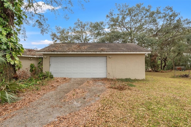 garage featuring a lawn