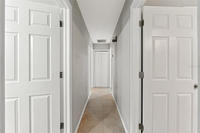 corridor with light tile patterned flooring