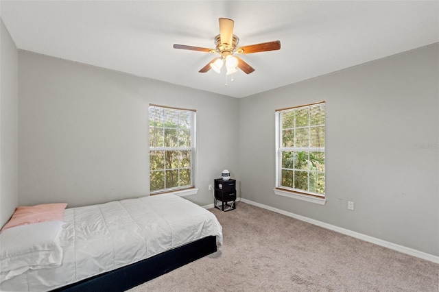 bedroom featuring ceiling fan and light carpet