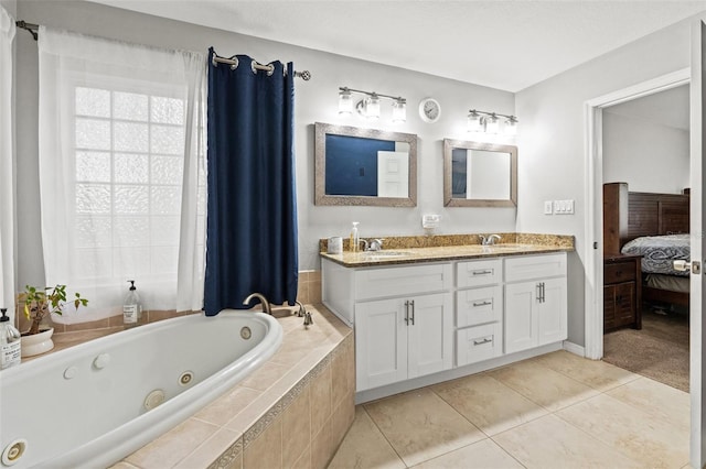 bathroom with vanity, tile patterned floors, and a relaxing tiled tub