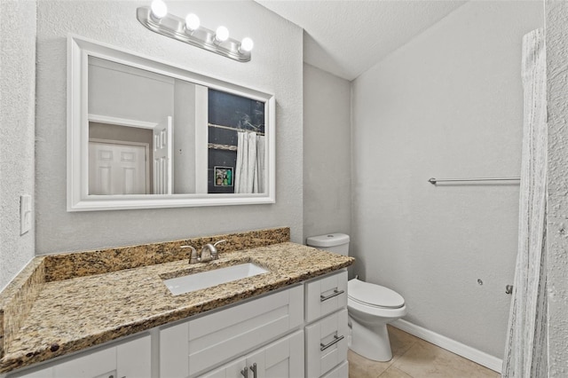 bathroom with toilet, tile patterned floors, vanity, and a textured ceiling