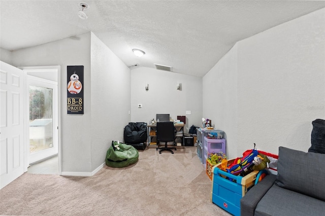 office space featuring a textured ceiling, light colored carpet, and lofted ceiling