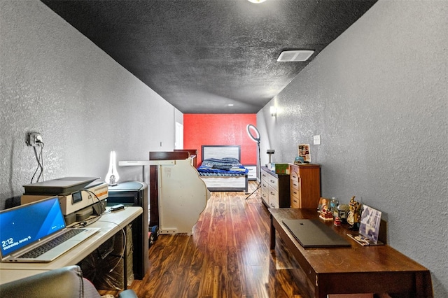 hallway featuring a textured ceiling and dark hardwood / wood-style floors