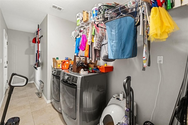 laundry area featuring independent washer and dryer and light tile patterned floors