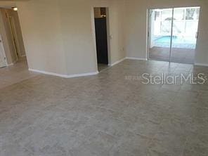 unfurnished room featuring baseboards