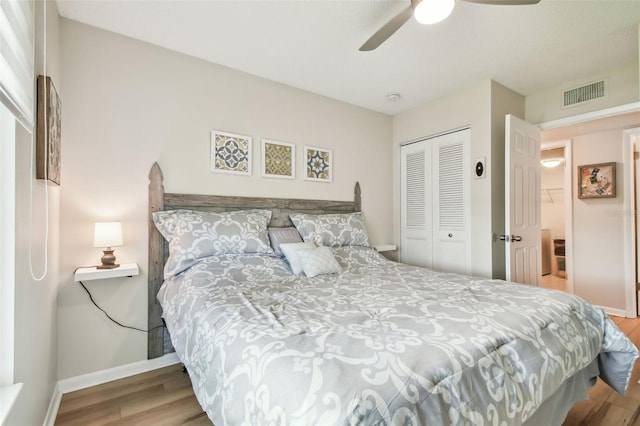 bedroom featuring ceiling fan, a closet, and light hardwood / wood-style floors