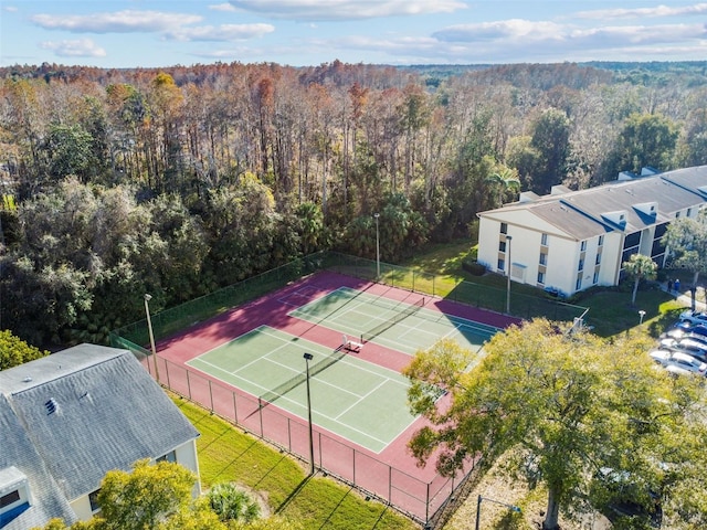 view of tennis court with a lawn