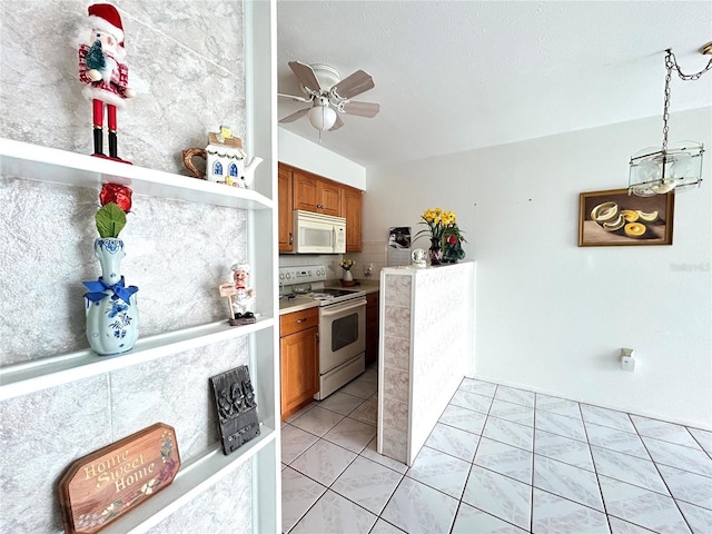 kitchen with ceiling fan, light tile patterned flooring, white appliances, and hanging light fixtures