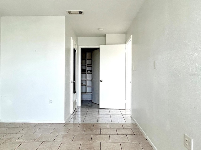 spare room featuring light tile patterned floors