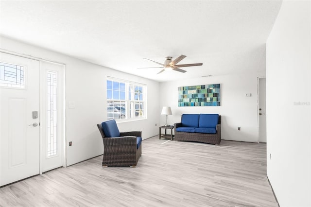 interior space featuring ceiling fan, a textured ceiling, and light hardwood / wood-style flooring