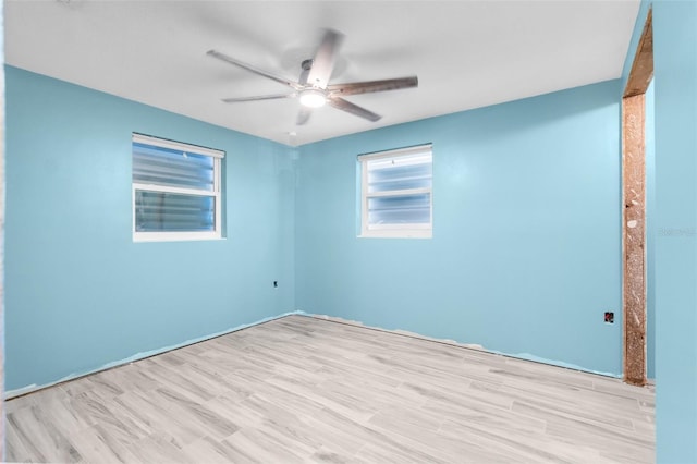 empty room featuring ceiling fan and light hardwood / wood-style floors