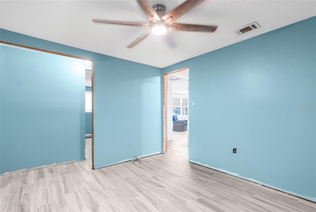 spare room with ceiling fan and light wood-type flooring