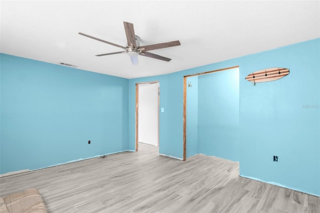 empty room with light hardwood / wood-style floors and ceiling fan