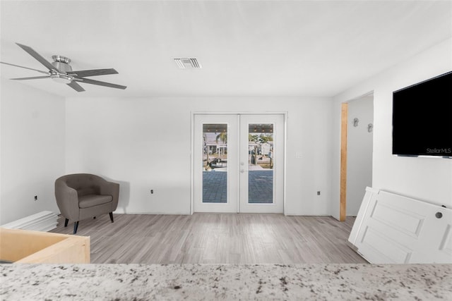 interior space featuring french doors, access to outside, ceiling fan, and light hardwood / wood-style floors