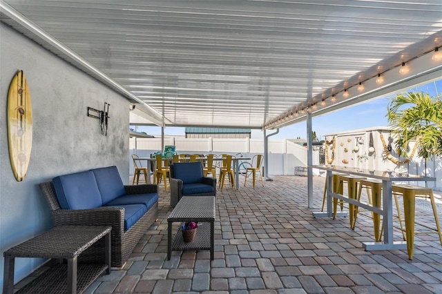 view of patio / terrace featuring an outdoor living space and an outdoor bar