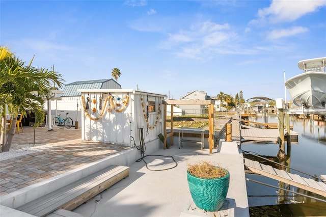 view of patio / terrace featuring a boat dock and a water view