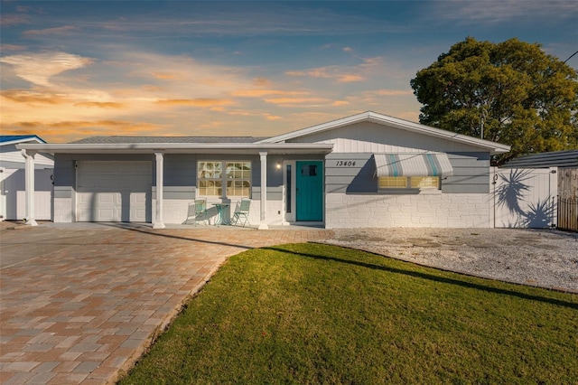 view of front facade with a garage and a yard