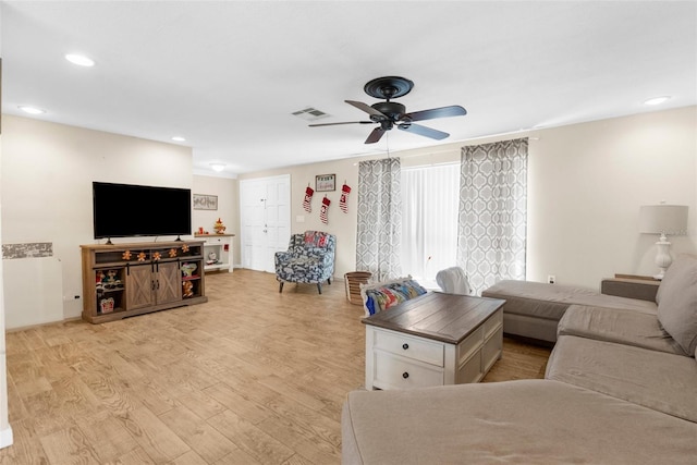 living room featuring ceiling fan and light wood-type flooring