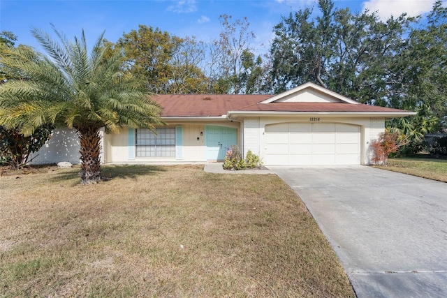 ranch-style home with a garage and a front lawn