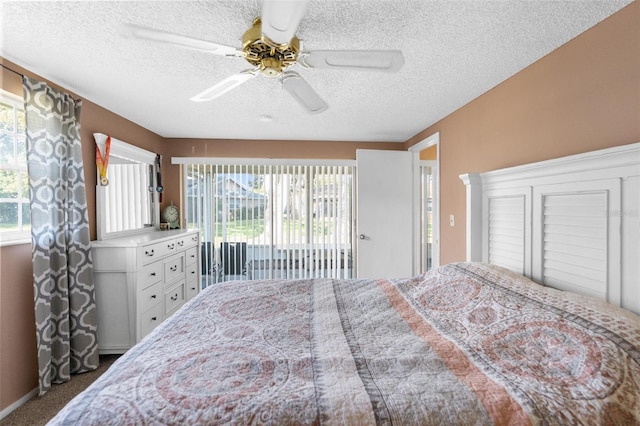 bedroom featuring multiple windows, carpet flooring, a textured ceiling, and ceiling fan