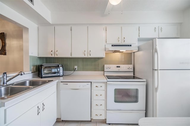 kitchen featuring decorative backsplash, white appliances, sink, light tile patterned floors, and white cabinets