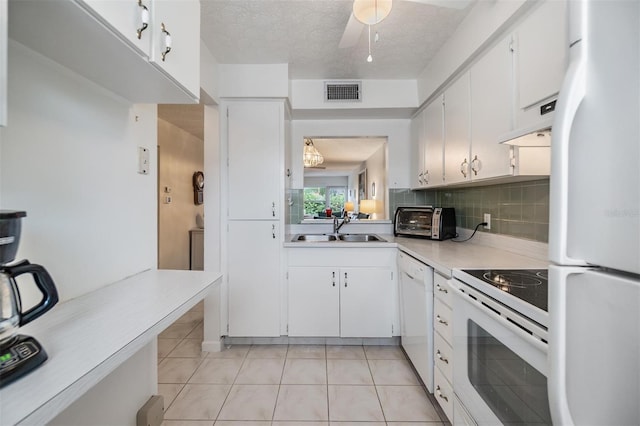 kitchen featuring white cabinets, light tile patterned floors, white appliances, and sink