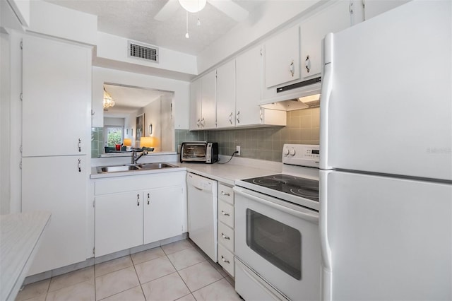 kitchen with backsplash, white appliances, sink, light tile patterned floors, and white cabinets