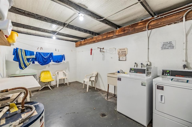 clothes washing area featuring separate washer and dryer and sink