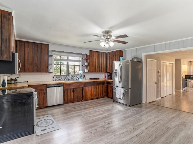 kitchen featuring sink, light hardwood / wood-style flooring, ceiling fan, appliances with stainless steel finishes, and dark brown cabinets