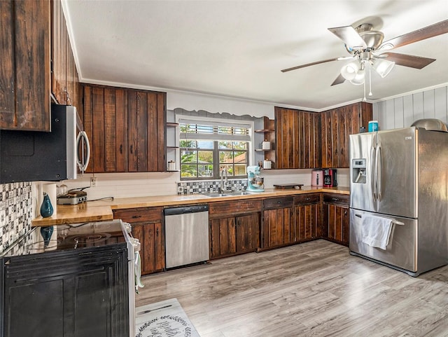 kitchen with dark brown cabinets, sink, appliances with stainless steel finishes, and light hardwood / wood-style flooring