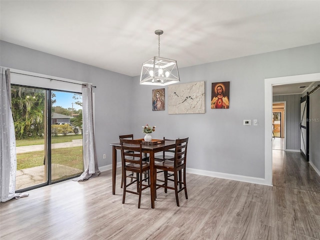 dining room featuring hardwood / wood-style floors and an inviting chandelier