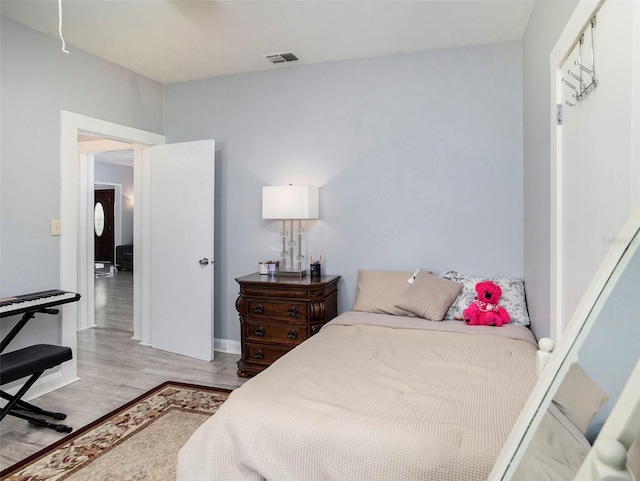 bedroom with light hardwood / wood-style floors