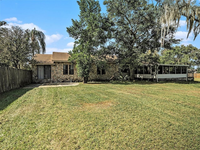 view of yard with a sunroom