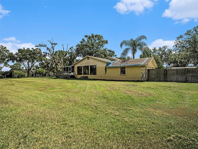 rear view of property featuring a yard