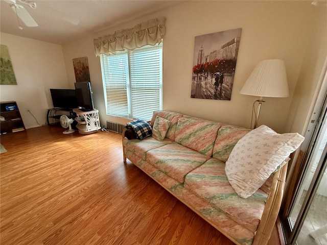 living room with ceiling fan, wood-type flooring, and radiator