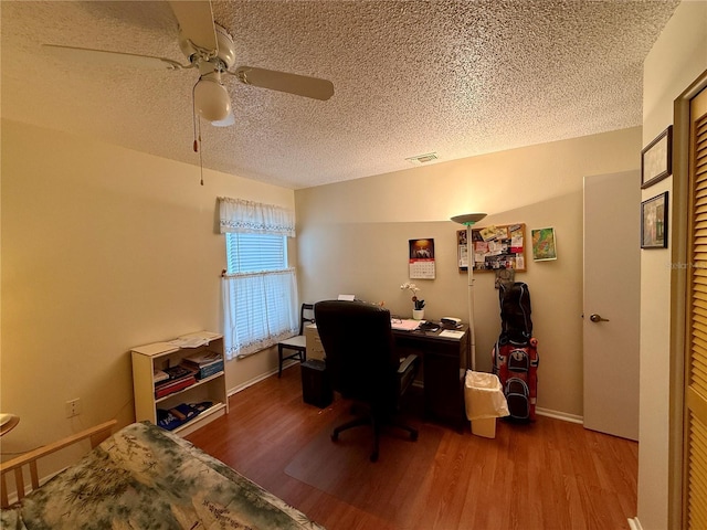 office with ceiling fan, a textured ceiling, and hardwood / wood-style flooring