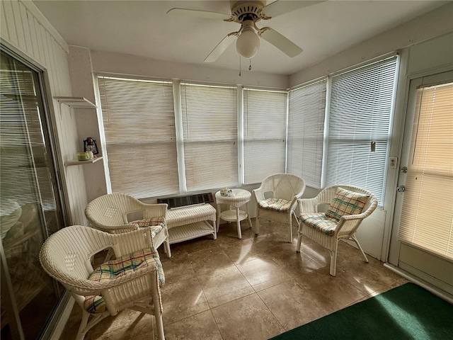 sunroom / solarium featuring ceiling fan