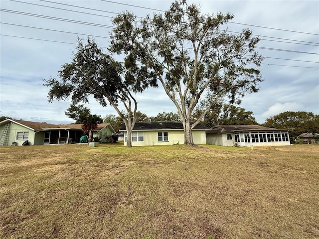 8704 Winding Wood Dr, Port Richey, FL 34668 - view of front of property featuring a sunroom and a front yard