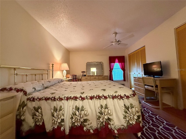 bedroom with a ceiling fan and a textured ceiling